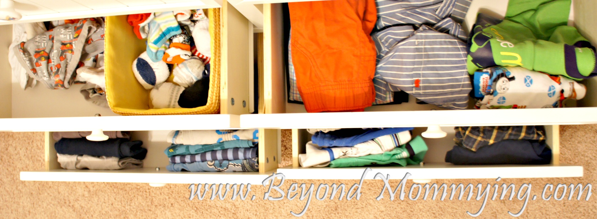 Organizing kid's laundry by putting different types of clothes in different drawers